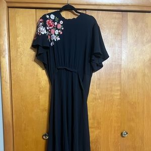 Black maxi dress with floral embroidery.